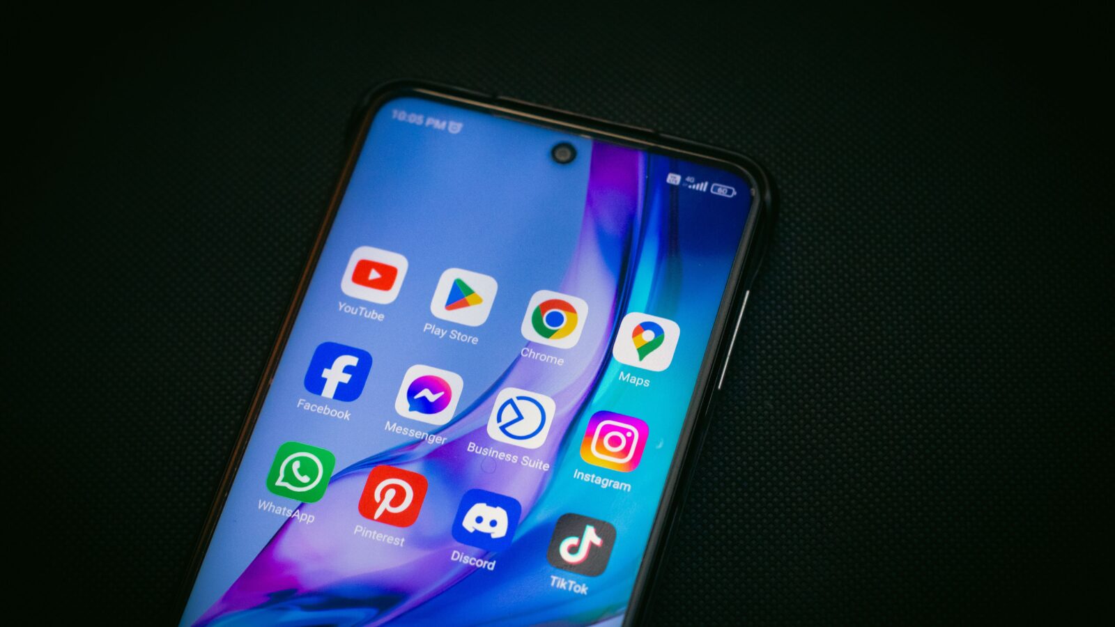 A smartphone home screen showing a Discord app icon among other messaging apps