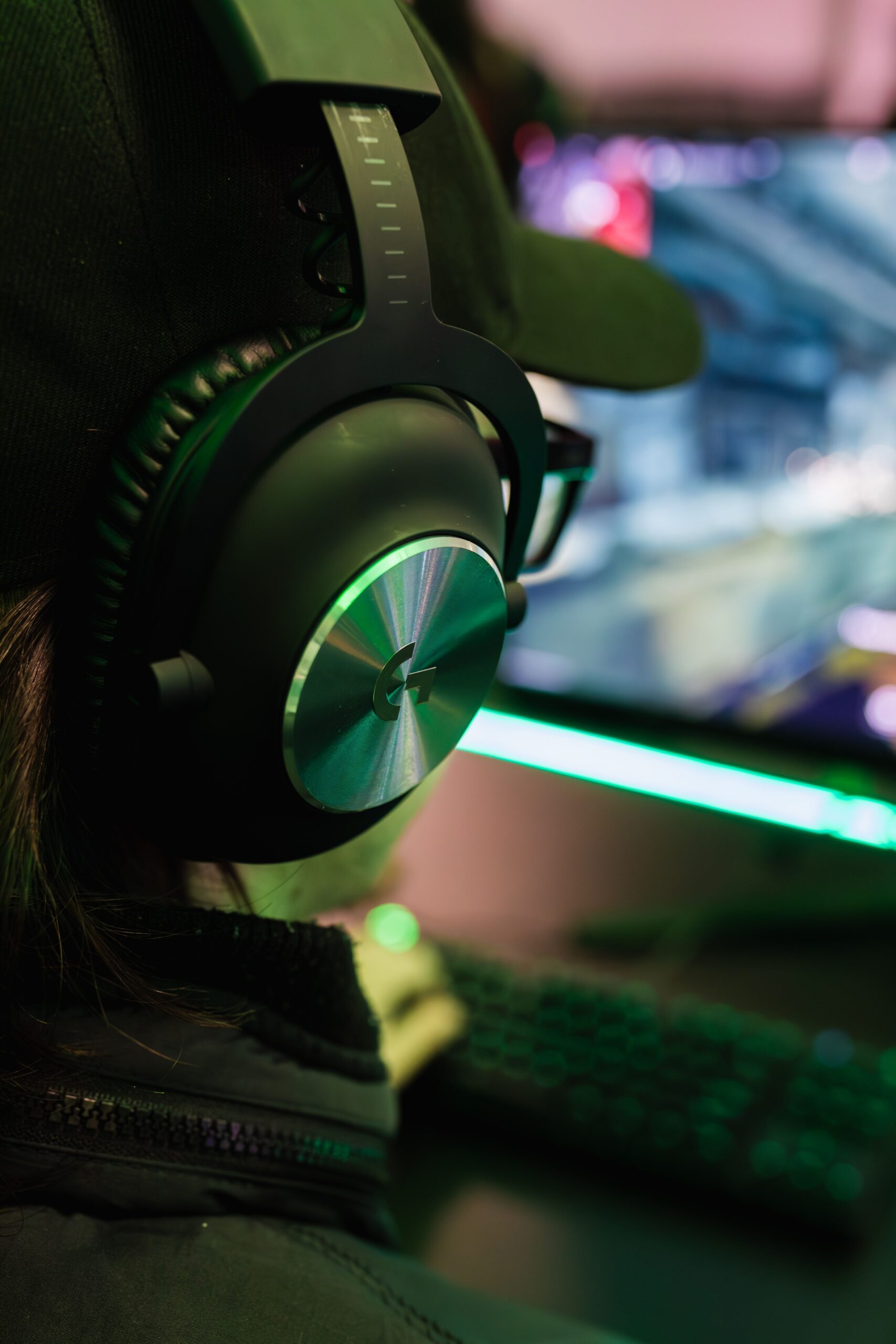 bertellifotografia, Pexels License, via https://www.pexels.com/photo/man-wearing-headphones-in-front-of-computer-18966483/ A member wearing a gaming headset at a computer, the kind of voice-channel user a TTS translator bot serves