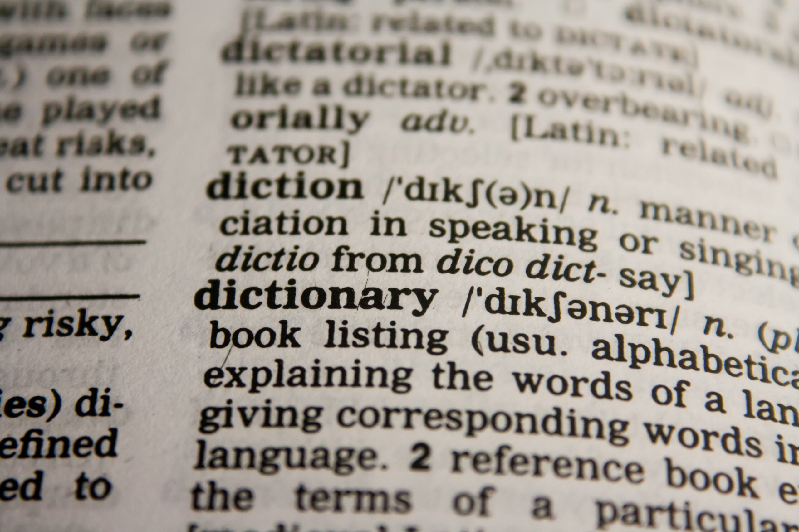 A close-up of an English dictionary page showing the entries for "diction" and "dictionary"