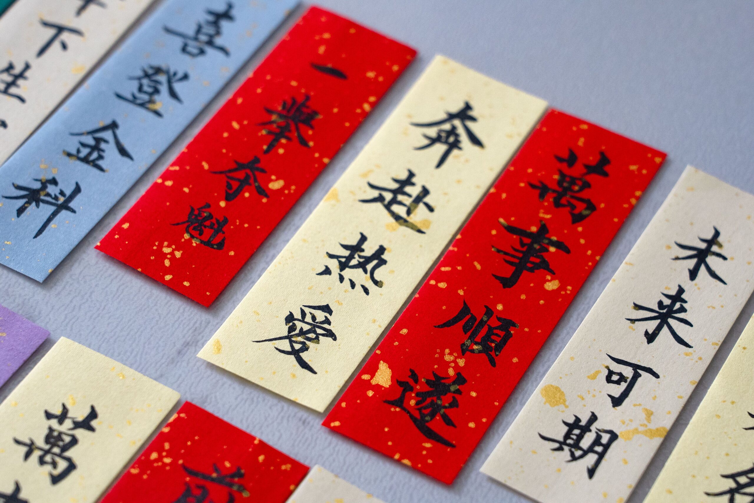 Colorful calligraphy banners in Chinese script, one of the writing systems a 100+ language set has to handle